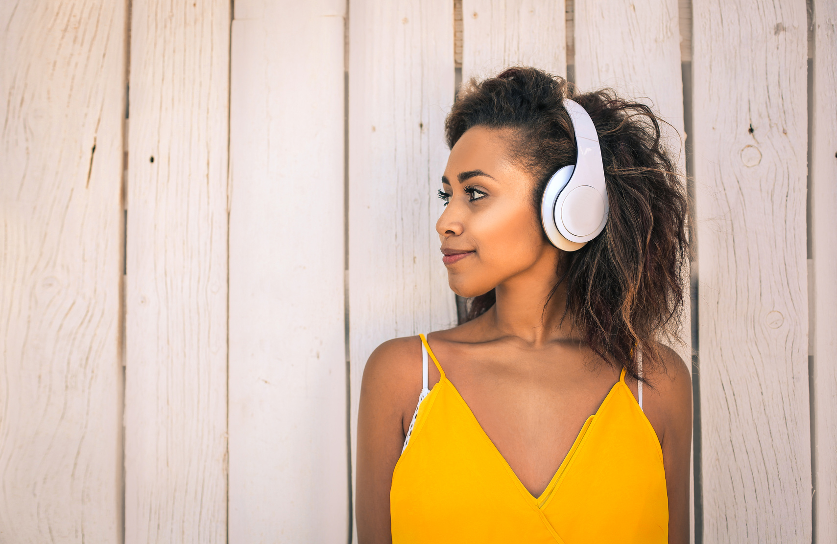 Portrait of a cool girl listening music with headphones